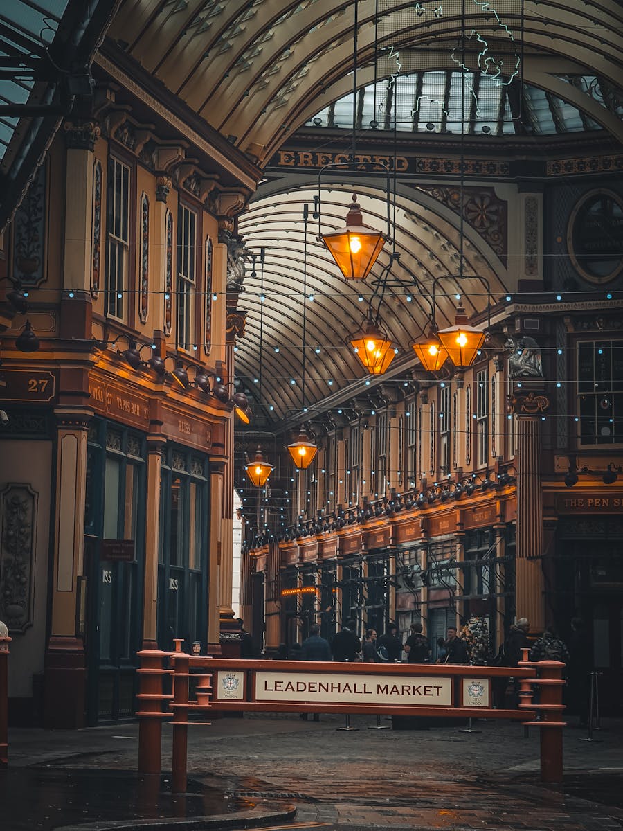 Leadenhall Market in London with vintage lamps and ornate architecture, view of historic shopping arcade
