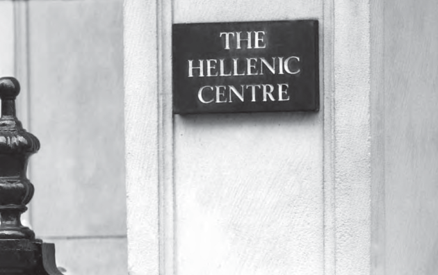 Sign of The Hellenic Centre on a building facade with decorative plants in foreground